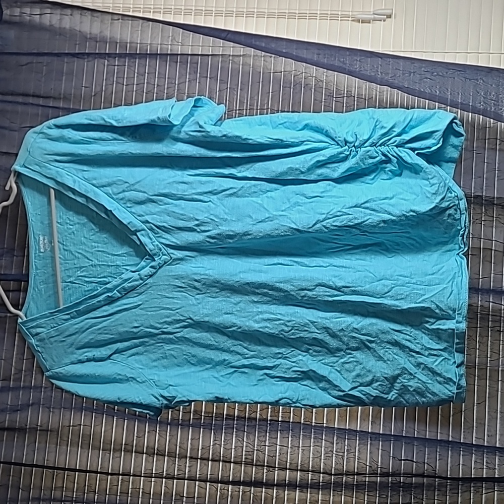 Light blue tee with a double collar V-neck.
